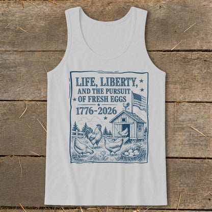 White tank top with "Life, Liberty, and the Pursuit of Fresh Eggs 1776-2026" graphic.