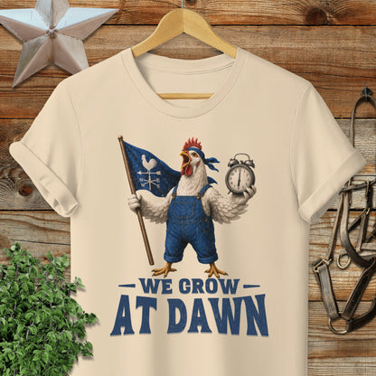 Chicken in overalls holding a flag and clock, text "WE GROW AT DAWN".