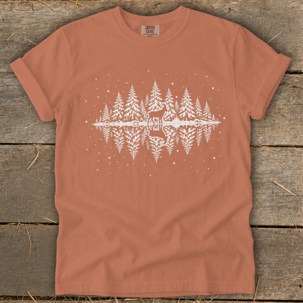 Orange t-shirt with white graphic of a deer and trees reflected in water