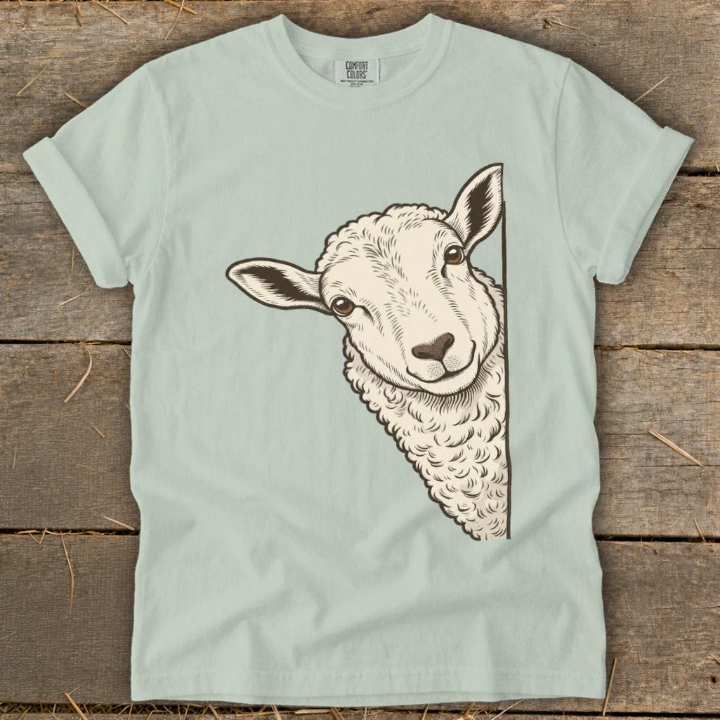 Light blue t-shirt with a drawing of a sheep peeking from the side.