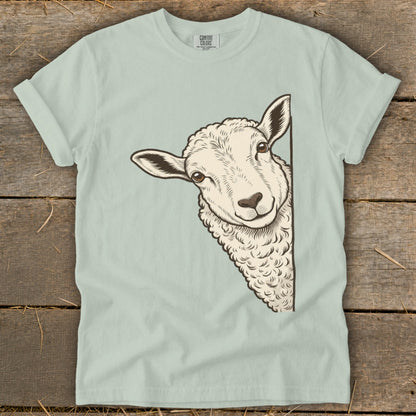 Light blue t-shirt with a drawing of a sheep peeking from the side.