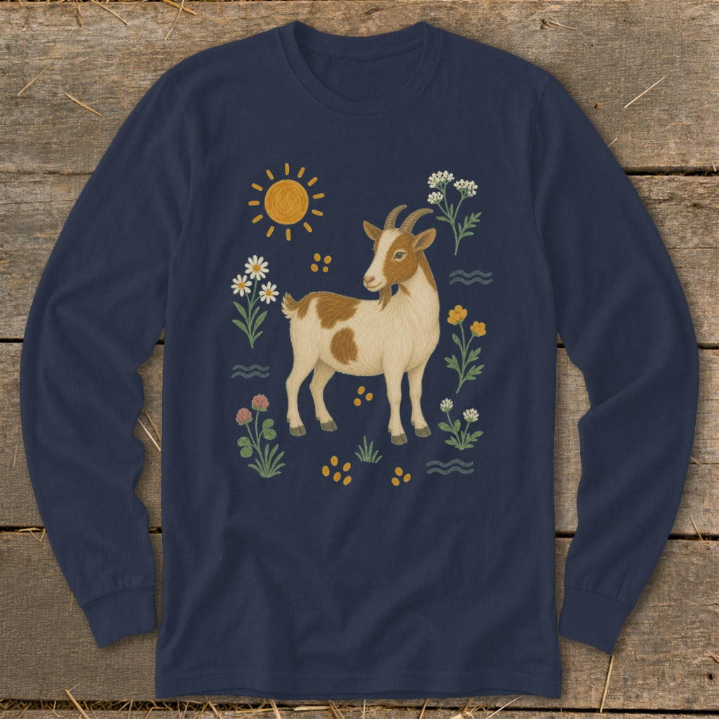 Brown and white goat with flowers, sun, and yellow dots on a navy long-sleeved shirt.