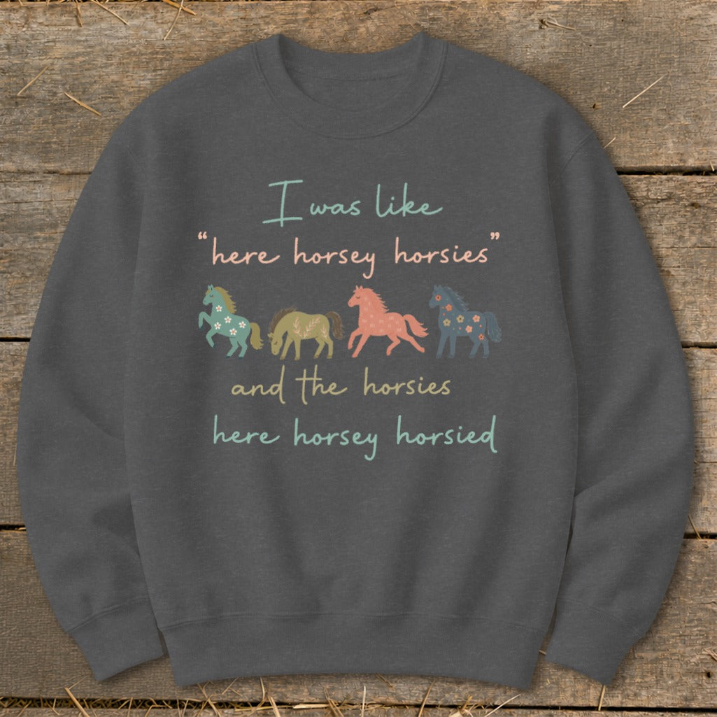 Dark gray sweatshirt with text and four stylized horses: "I was like 'here horsey horsies' and the horsies here horsey horsied".