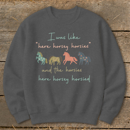 Dark gray sweatshirt with text and four stylized horses: "I was like 'here horsey horsies' and the horsies here horsey horsied".