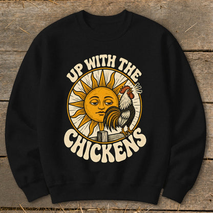 A black crewneck sweatshirt printed with a vintage illustration of a sun and rooster, captioned Up With The Chickens.
