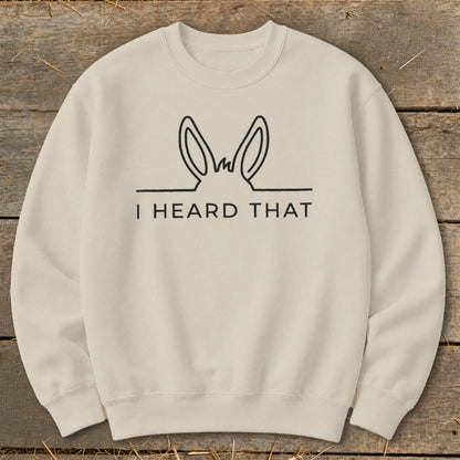 Cream crewneck sweatshirt with black graphic of donkey ears and text "I HEARD THAT."