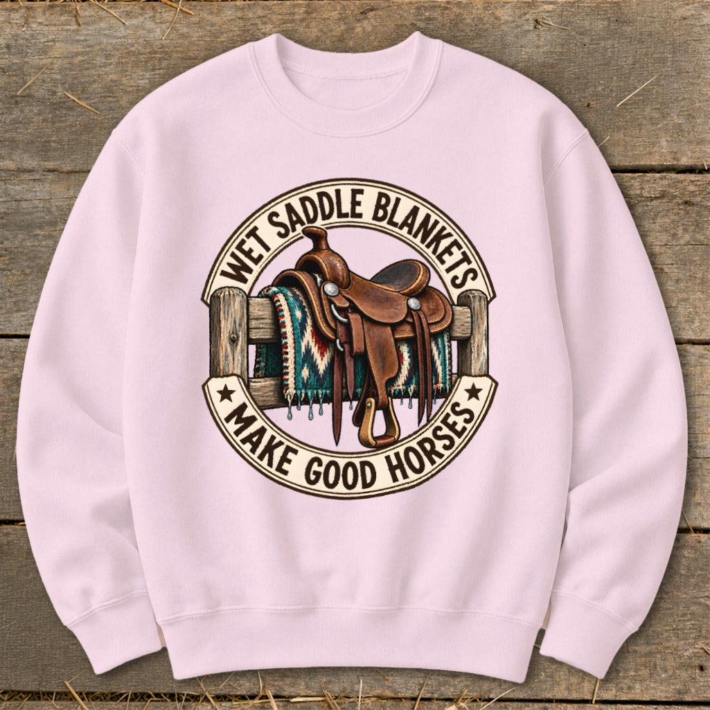 Pink sweatshirt with a circular graphic of a saddle on a blanket and fence.