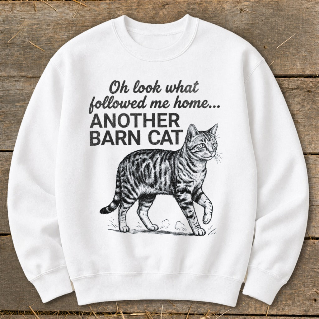 White sweatshirt with text "Oh look what followed me home... ANOTHER BARN CAT" and a cat illustration.