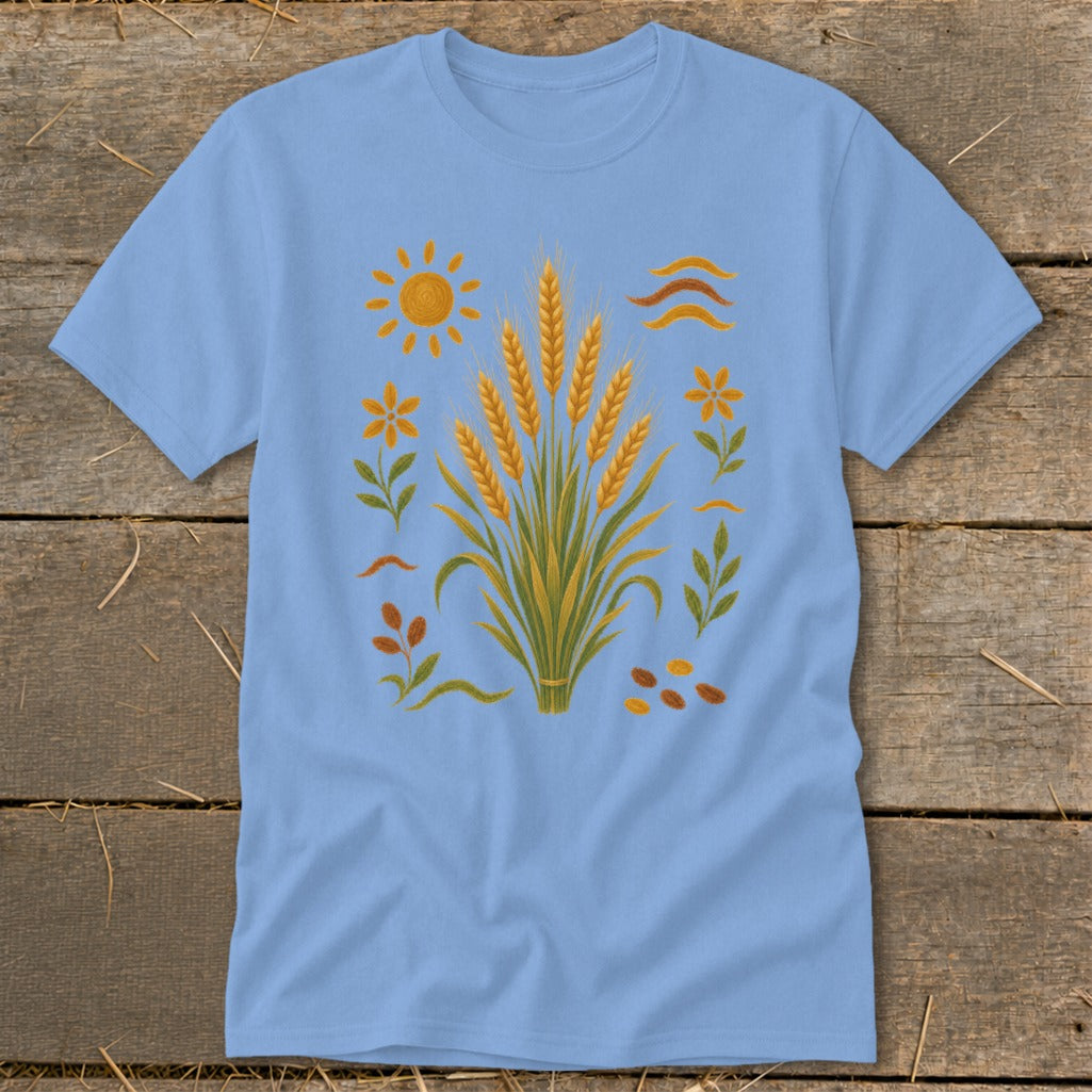 Light blue t-shirt with a central wheat stalk design and surrounding sun, flowers, and leaves.