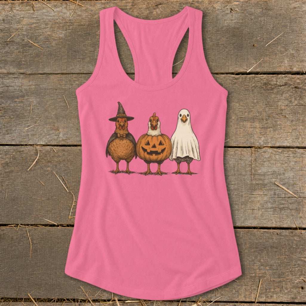 Three chickens dressed for Halloween: witch, jack-o'-lantern, and ghost.