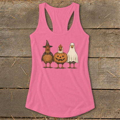 Three chickens dressed for Halloween: witch, jack-o'-lantern, and ghost.