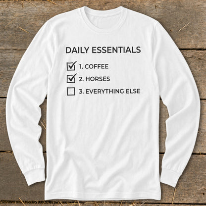 White long sleeve shirt with "Daily Essentials" and a checklist including coffee and horses.