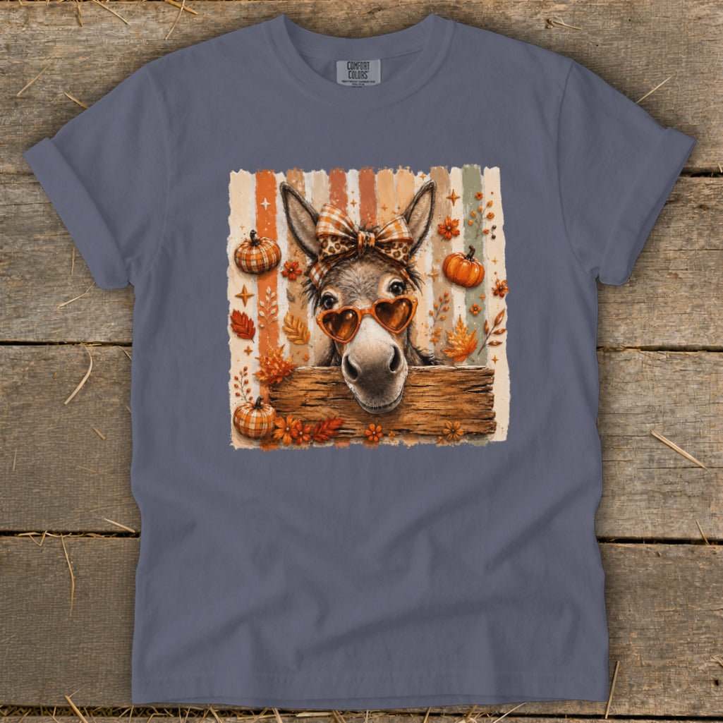 Donkey with heart sunglasses, plaid bow, and autumn leaves on striped background.