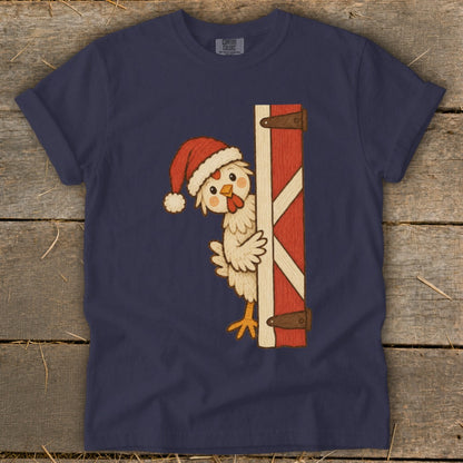 Navy t-shirt with a cartoon chicken wearing a Santa hat peeking from behind a red barn door.