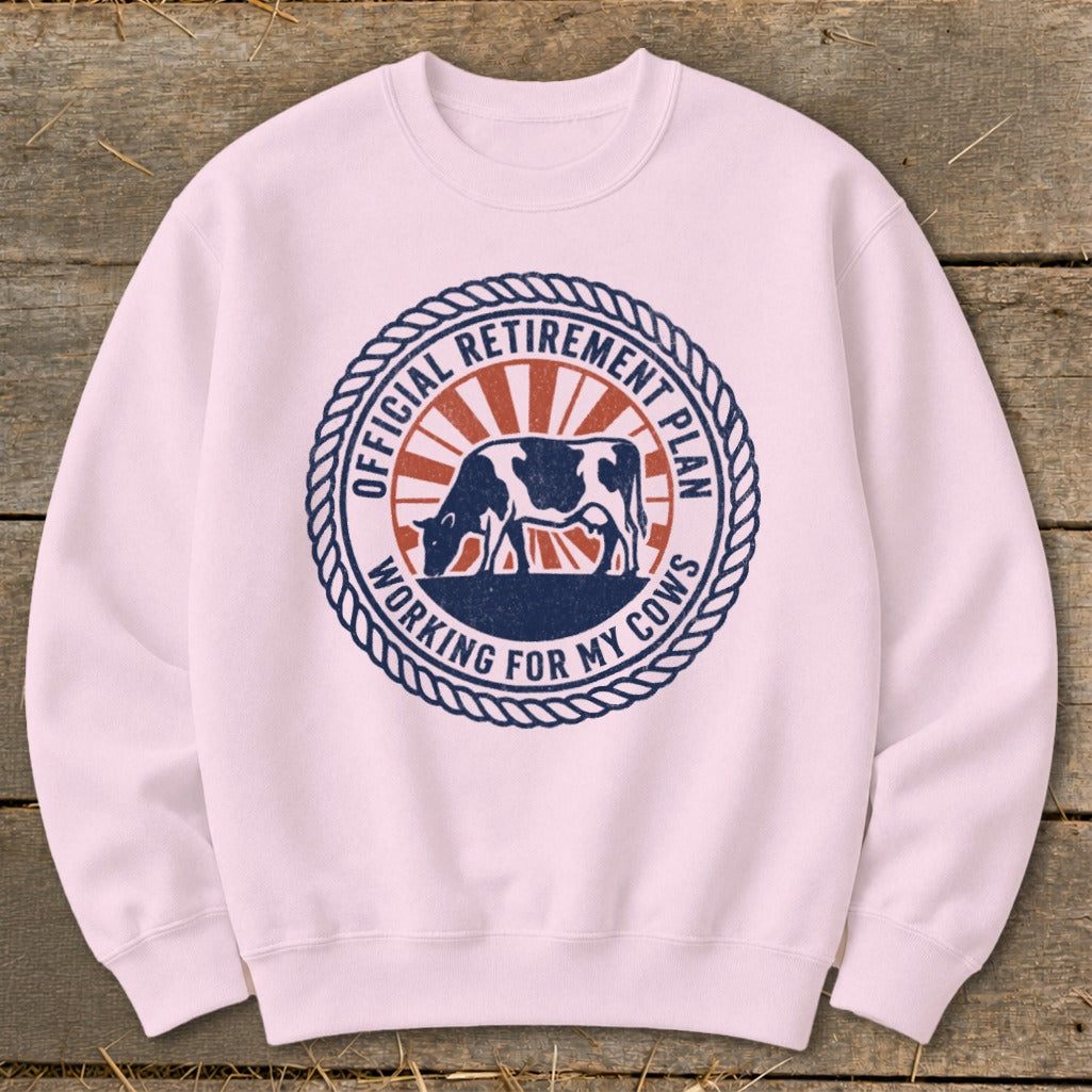Pink sweatshirt with a circular graphic of a cow and the text "Official Retirement Plan Working For My Cows".