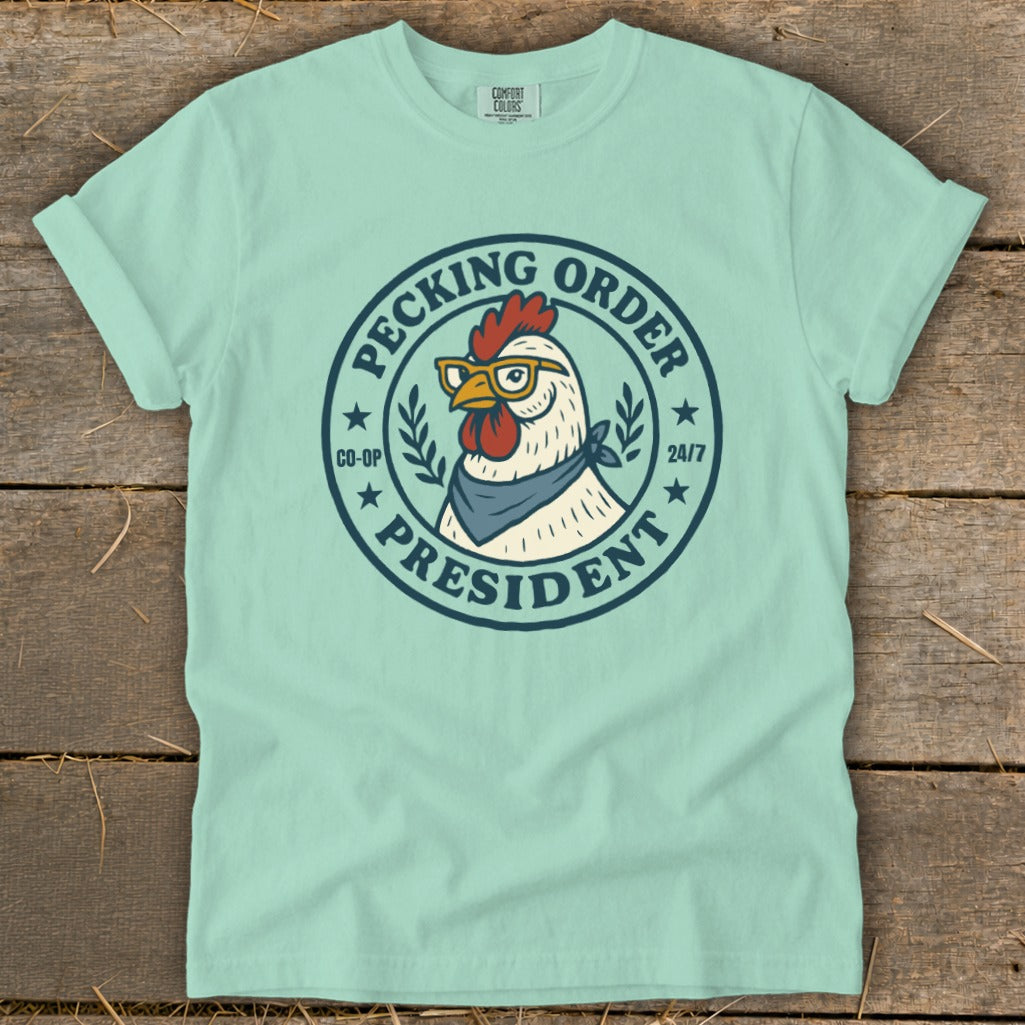 Mint t-shirt with graphic of chicken wearing glasses and bandana, text "Pecking Order President".