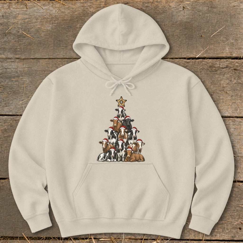 Cream hoodie with a Christmas tree made of cows wearing Santa hats.