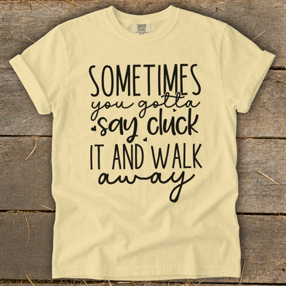 Yellow t-shirt with black text "Sometimes you gotta say cluck it and walk away".