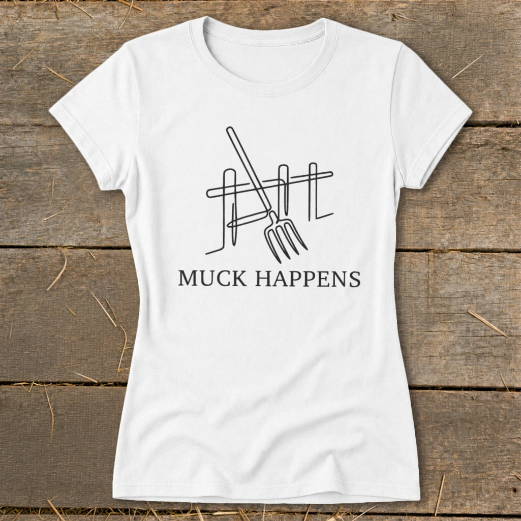 White t-shirt with line art of pitchfork and fence, text "MUCK HAPPENS".