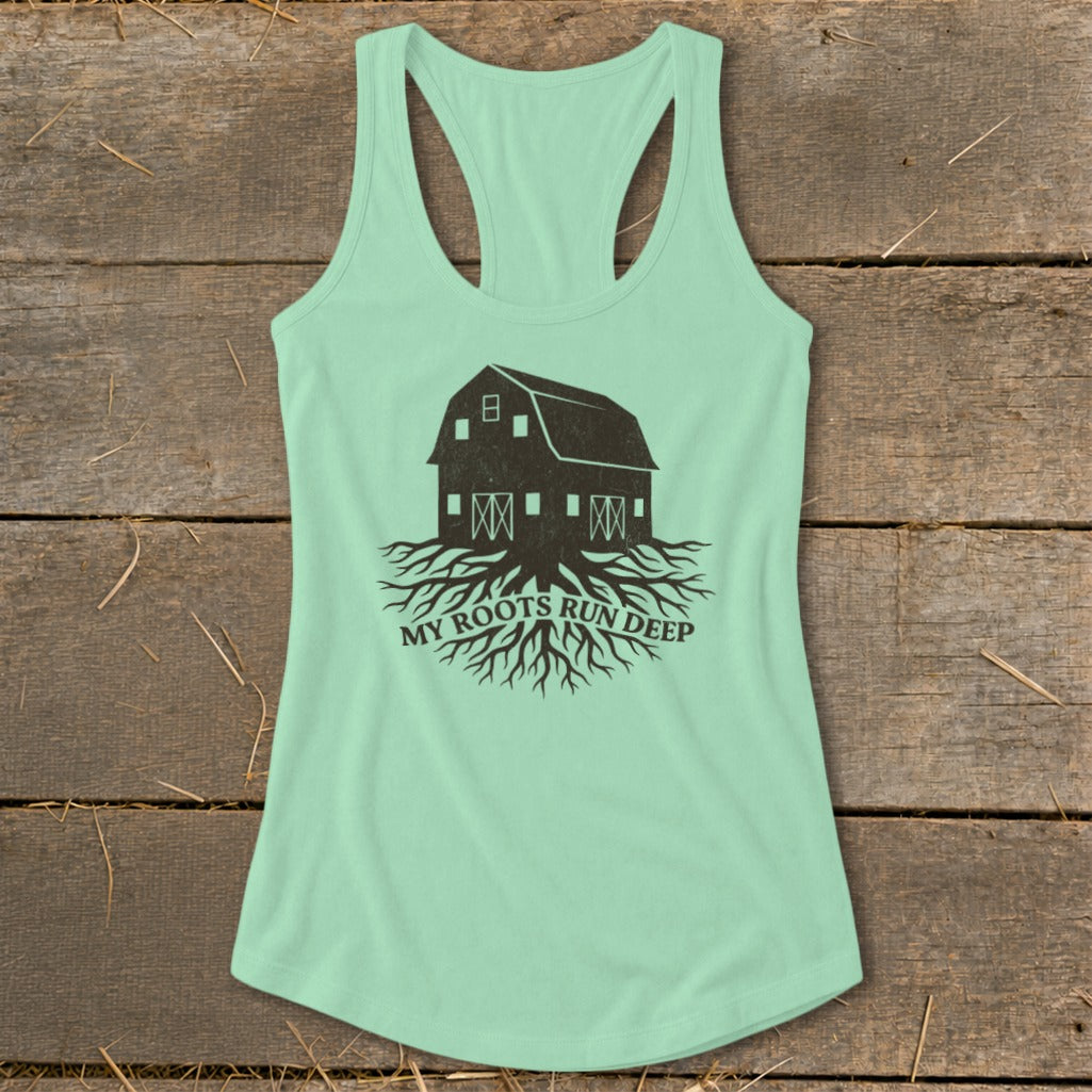 Mint green tank top with black barn and roots graphic and text.