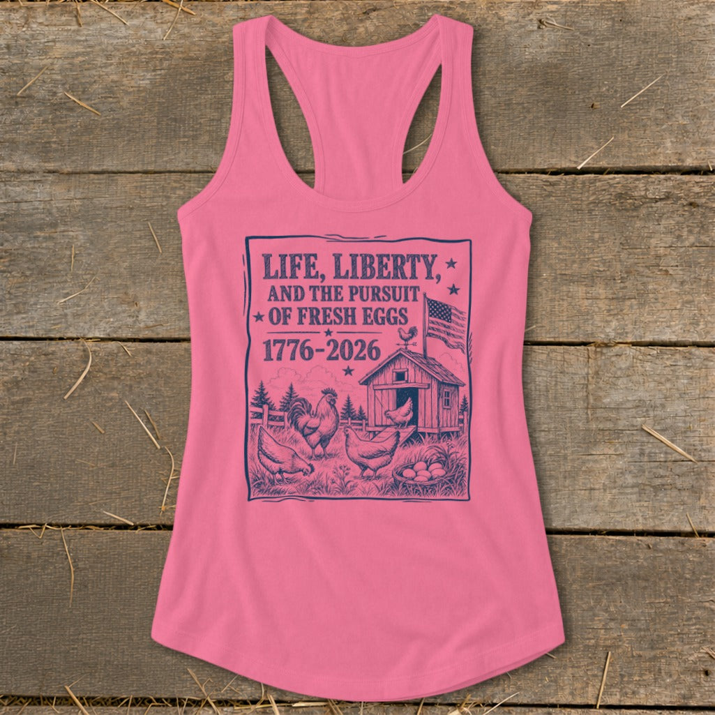 Pink tank top with graphic: "LIFE, LIBERTY, AND THE PURSUIT OF FRESH EGGS" with chickens and barn.