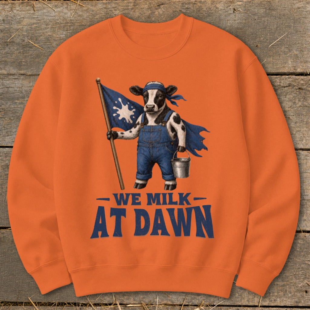Cow in overalls holding a flag with milk splash, wearing blue cape. Text reads "WE MILK AT DAWN".