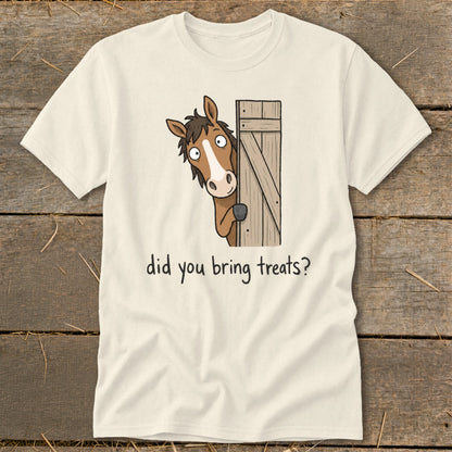 Cream t-shirt with cartoon horse peeking from wooden fence asking "did you bring treats?"