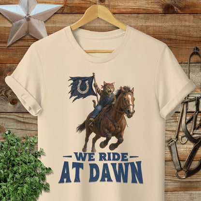 Cat cowboy on horseback with flag, text "WE RIDE AT DAWN".