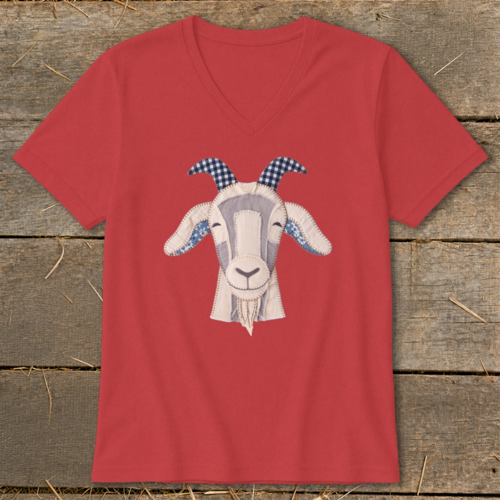 Red v-neck t-shirt with a fabric applique of a smiling goat's face.