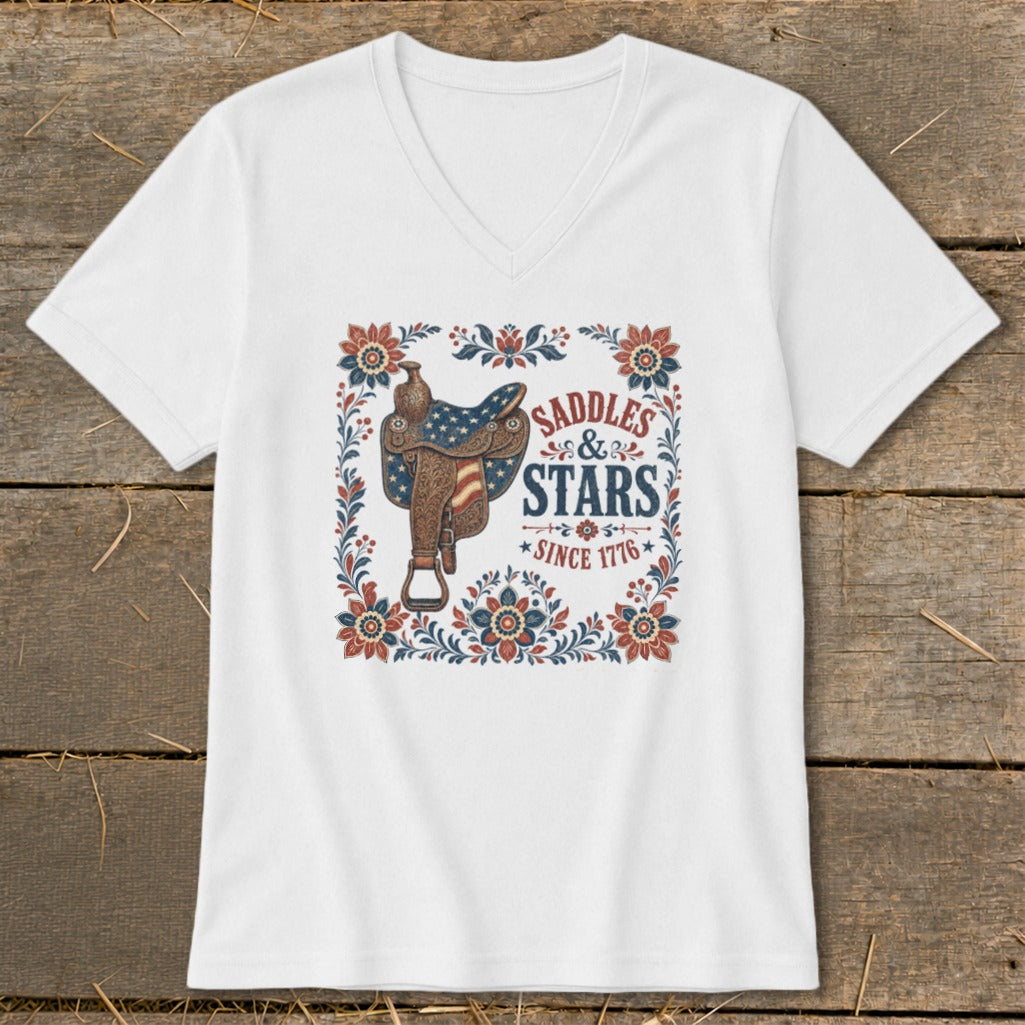 White v-neck t-shirt with "Saddles & Stars Since 1776" text and American flag saddle.