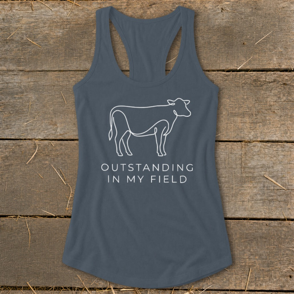 Grey tank top with a white line drawing of a cow and text reading "OUTSTANDING IN MY FIELD".