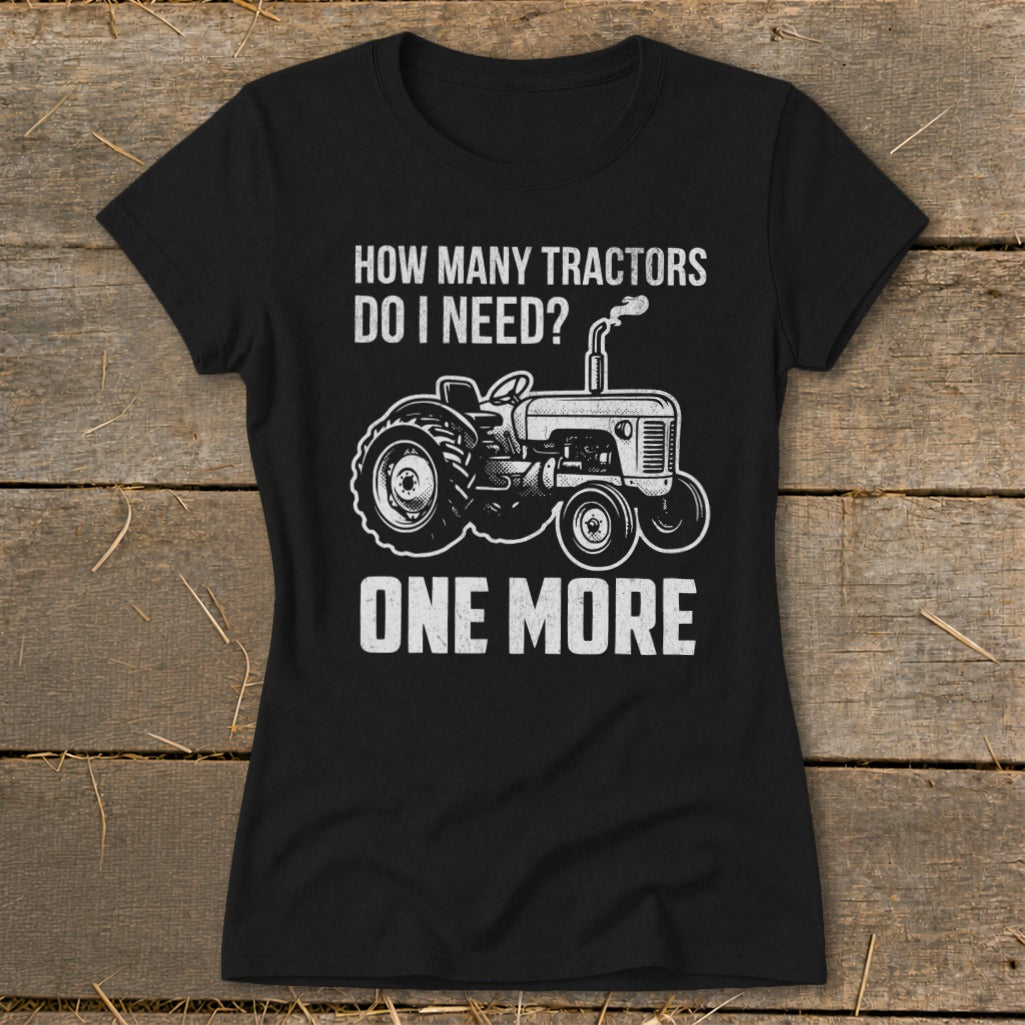 Black t-shirt with white text and tractor graphic: "How Many Tractors Do I Need? One More."