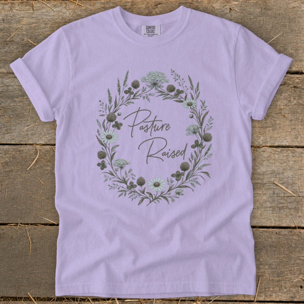 Lilac t-shirt with a floral wreath and "Pasture Raised" text.