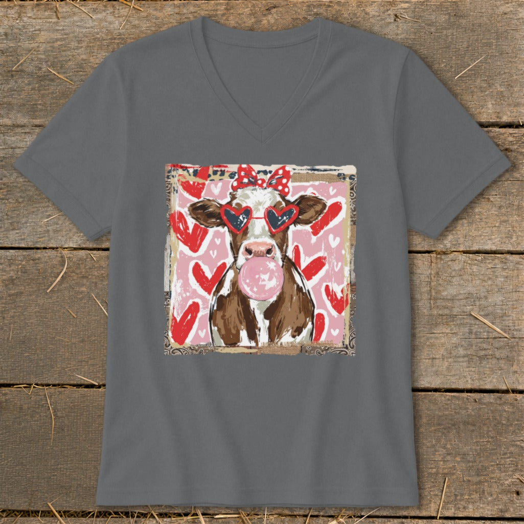 Cow wearing heart sunglasses and bow, blowing pink bubblegum against a heart background.