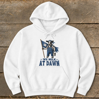 White hoodie with a cow holding a flag and text that reads "We Milk At Dawn."