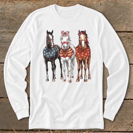 Three horses in patriotic attire, one black, one white, and one brown.