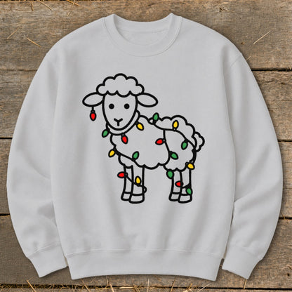 Light grey crewneck sweatshirt featuring a line-art illustration of a sheep wrapped in colorful Christmas lights.