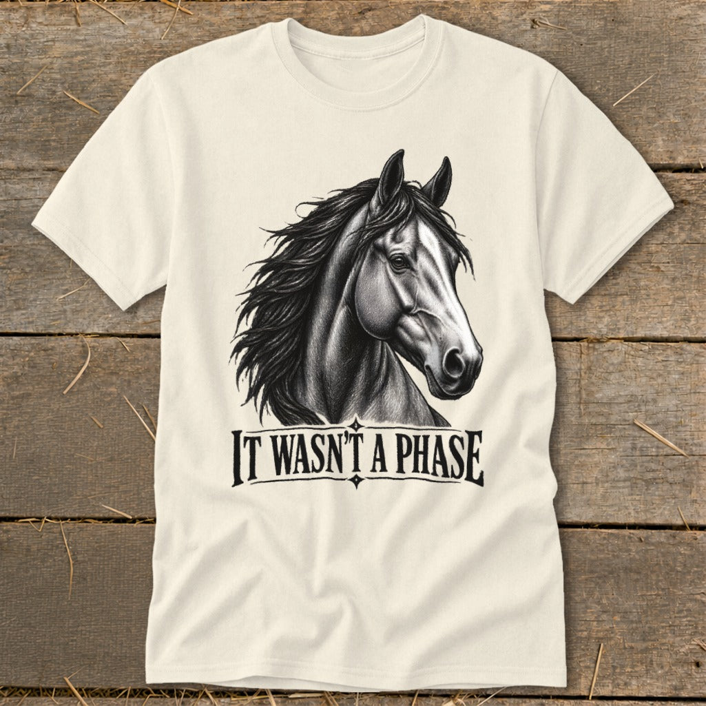 Cream t-shirt with a black and white drawing of a horse head and the text "IT WASN'T A PHASE".