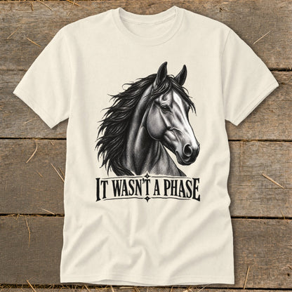 Cream t-shirt with a black and white drawing of a horse head and the text "IT WASN'T A PHASE".