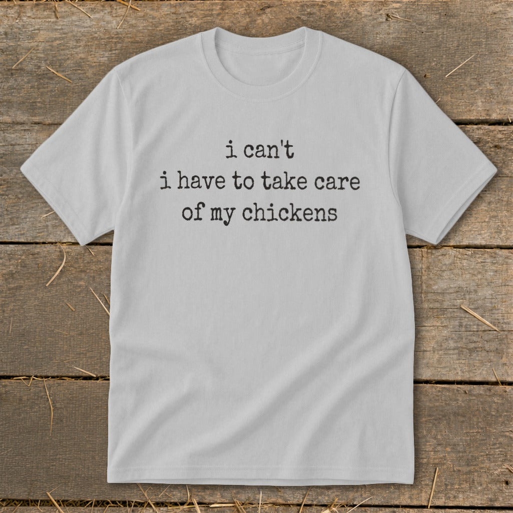 Light grey t-shirt with black text that reads "i can't i have to take care of my chickens."