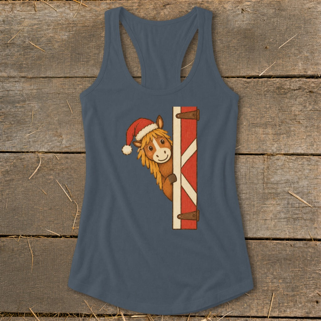 Horse wearing a Santa hat peeking from a red and white barn door.