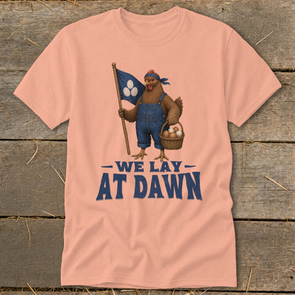 Peach t-shirt with a chicken in overalls holding a flag and basket of eggs with text "WE LAY AT DAWN".