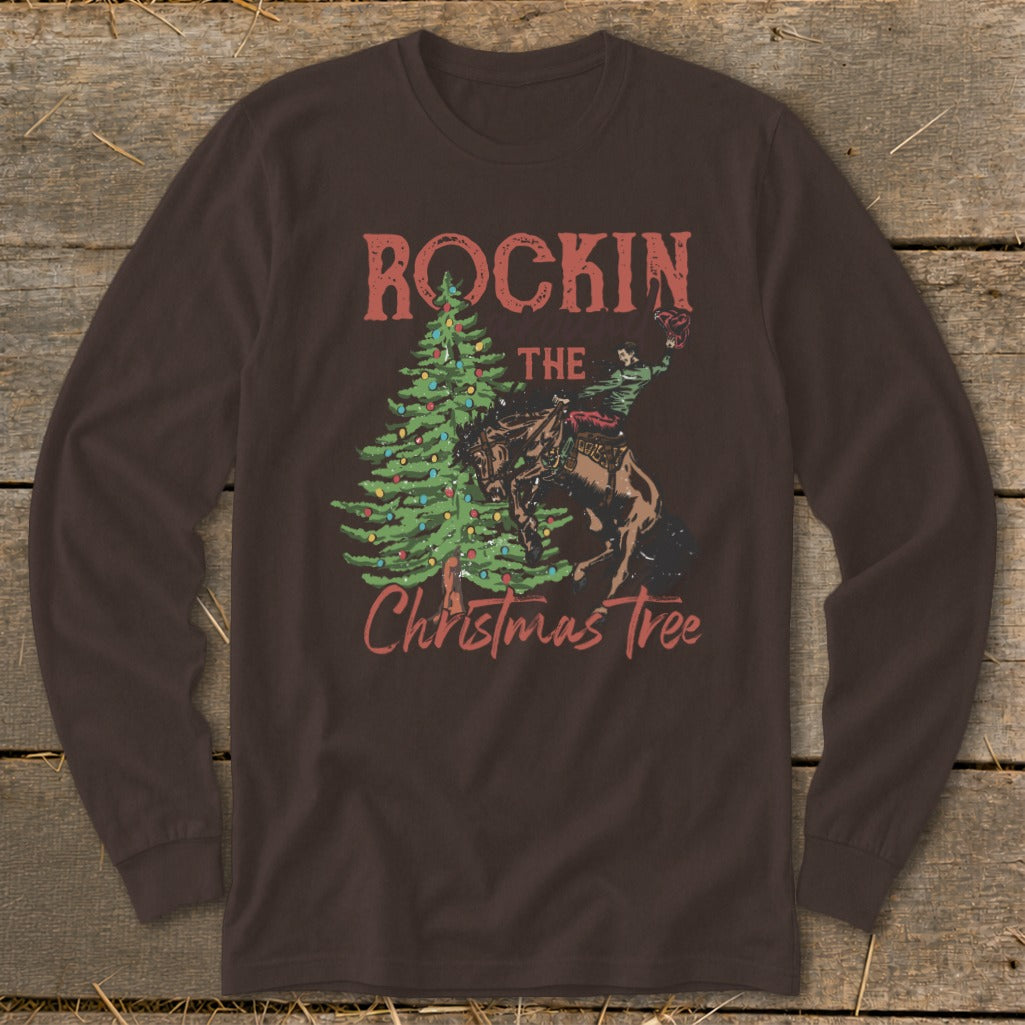 Brown long-sleeve shirt with "Rockin The Christmas Tree" graphic featuring a rodeo rider and a Christmas tree.