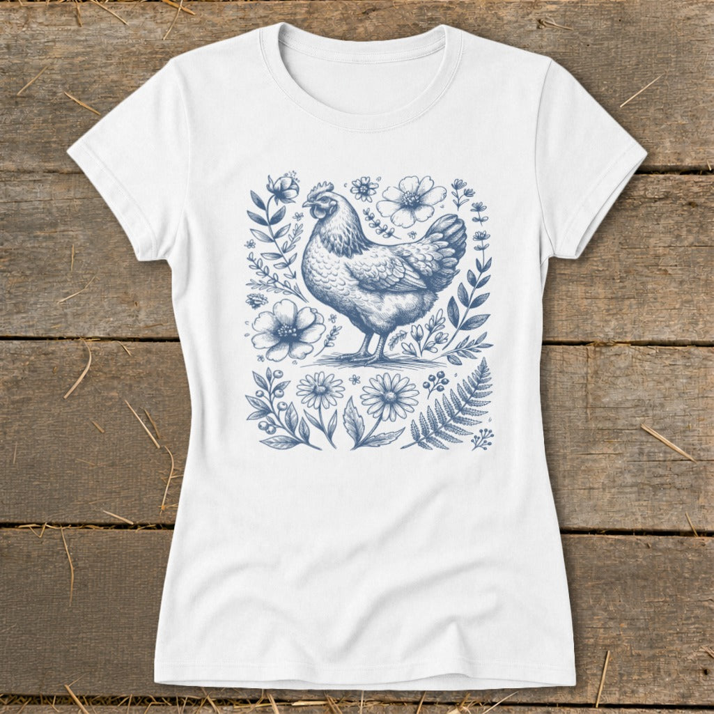 White t-shirt with a blue line drawing of a chicken surrounded by flowers and leaves.