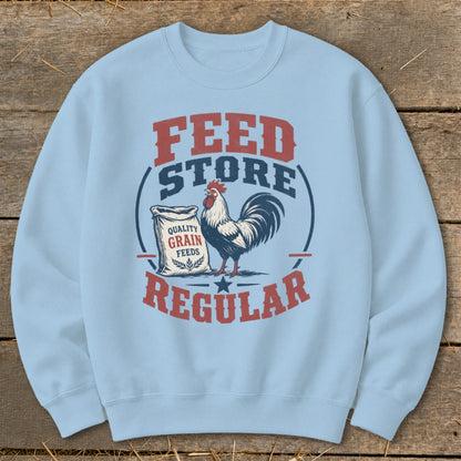 Light blue sweatshirt with "FEED STORE REGULAR" text and a rooster by a grain feed bag.