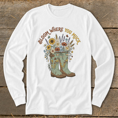 White long sleeve shirt with green boots filled with flowers and text "Bloom Where You Muck".