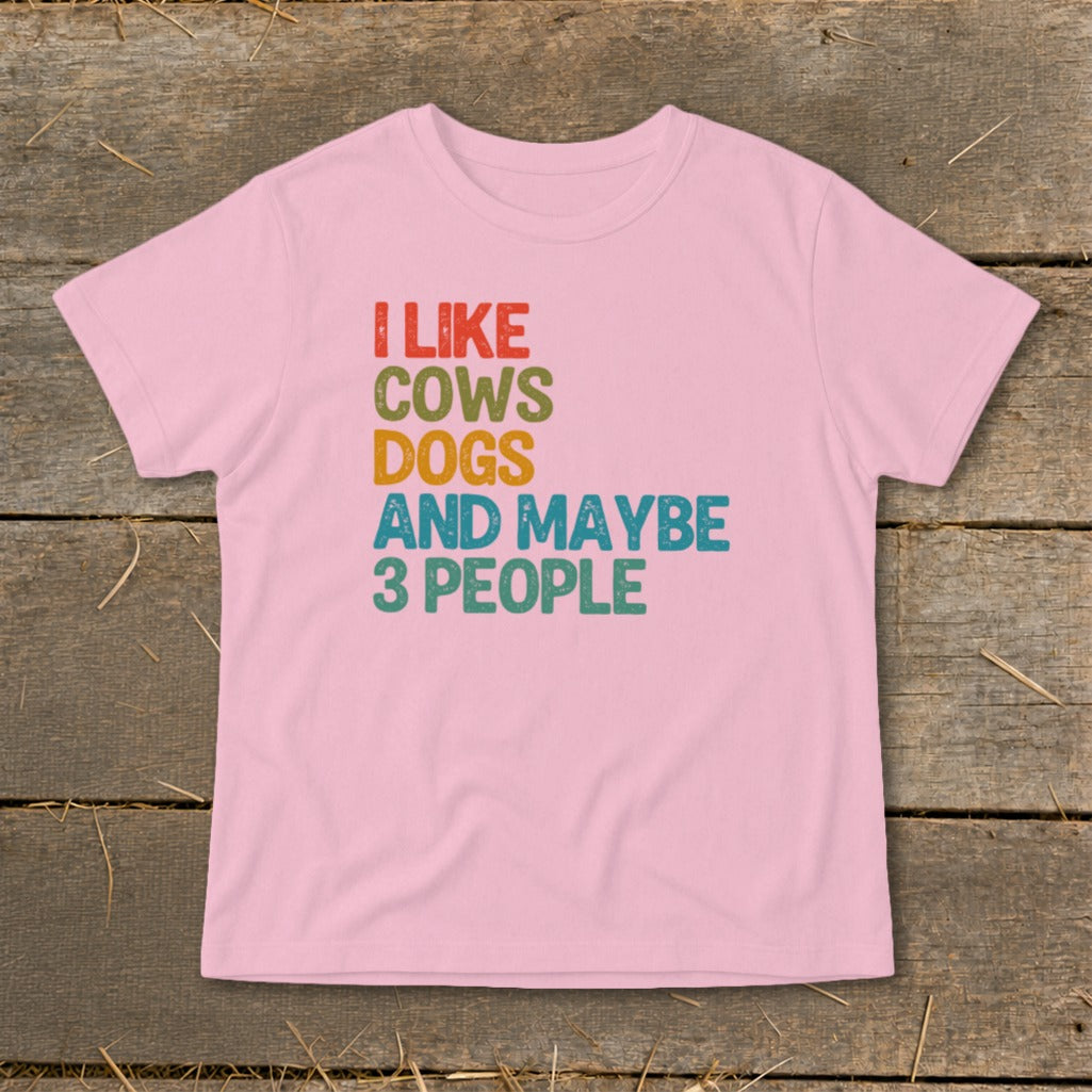 Pink t-shirt with text "I LIKE COWS DOGS AND MAYBE 3 PEOPLE"