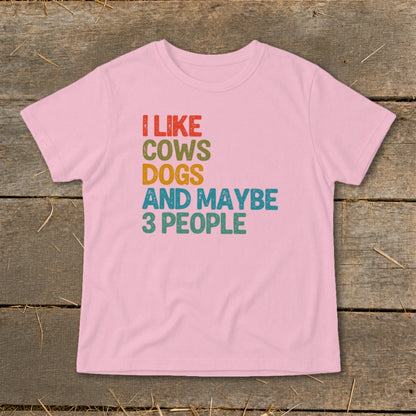 Pink t-shirt with text "I LIKE COWS DOGS AND MAYBE 3 PEOPLE"