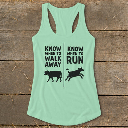 Mint green tank top with black text and cow silhouettes.