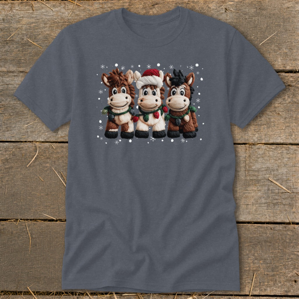 Three cartoon horses wearing Santa hats and Christmas lights stand together.